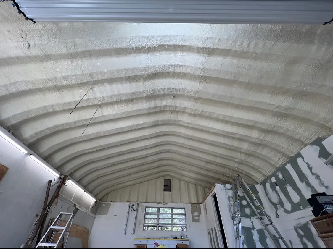 Spray polyurethane foam applied to the underside of a metal roof deck in Redwood Falls